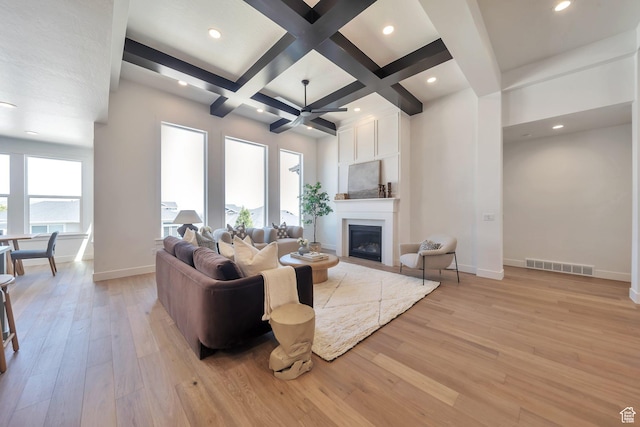 7991 S Ambrosia Ln, West Jordan, UT 84081 - living room with a fireplace, light wood-type flooring, beamed ceiling, coffered ceiling, and a ceiling fan