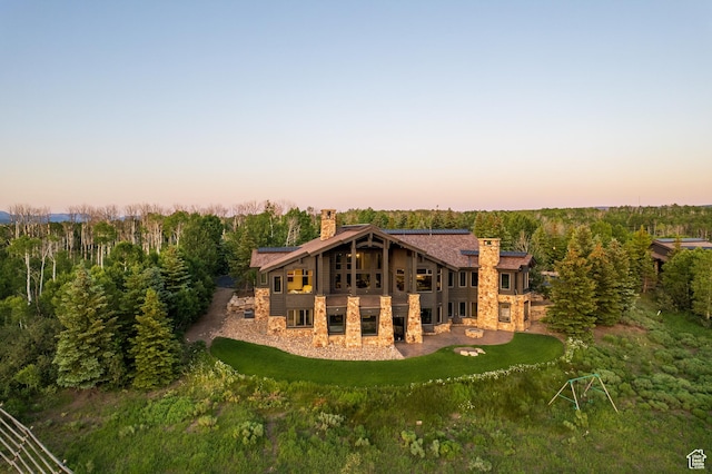 9156 E Forest Rd Unit 24, Heber City, UT 84032 - back of property with a chimney, stone siding, a patio, and a wooded view