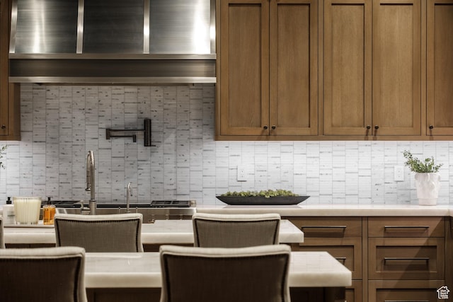 9156 E Forest Rd Unit 24, Heber City, UT 84032 - kitchen featuring backsplash, light countertops, and brown cabinetry