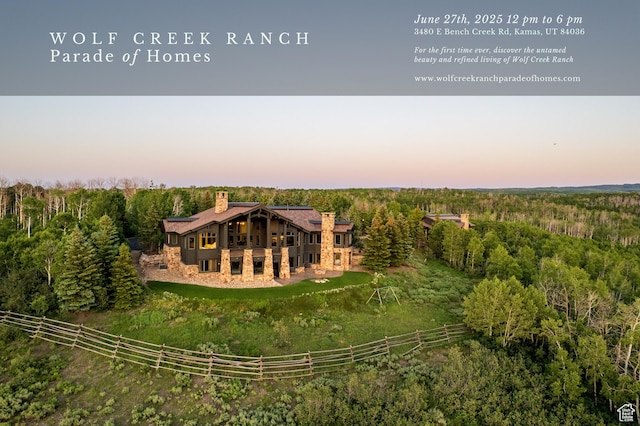 9156 E Forest Rd Unit 24, Heber City, UT 84032 - back of property with a chimney, a view of trees, and a wooden deck