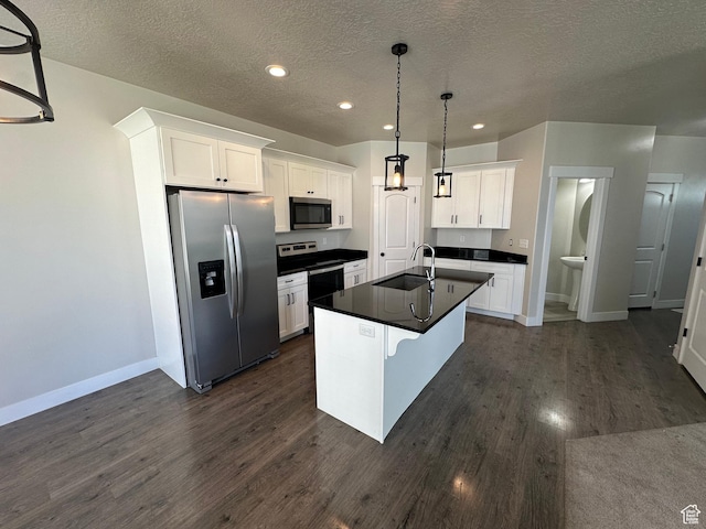 1738 W Terra Vis, Saratoga Springs, UT 84045 - kitchen with stainless steel appliances, dark countertops, a textured ceiling, white cabinets, and dark wood-type flooring