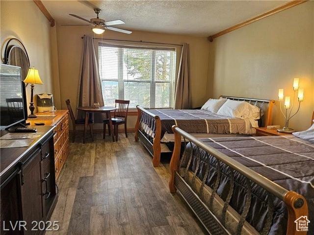 223 Hunter Ridge Rd Unit E121, Brian Head, UT 84719 - bedroom featuring dark wood-type flooring, crown molding, and a textured ceiling