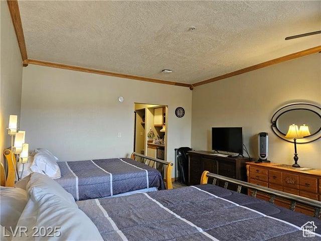 223 Hunter Ridge Rd Unit E121, Brian Head, UT 84719 - bedroom featuring ornamental molding and a textured ceiling