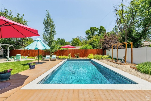 1680 E Fieldcrest Ln, Holladay, UT 84117 - view of swimming pool with a wooden deck, a fenced backyard, and a patio area