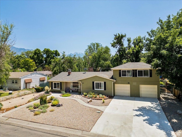 1680 E Fieldcrest Ln, Holladay, UT 84117 - view of front of property featuring a garage, concrete driveway, and a mountain view