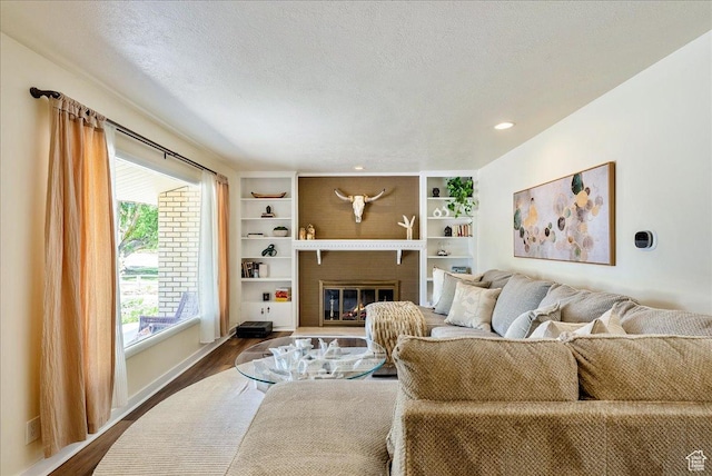 1680 E Fieldcrest Ln, Holladay, UT 84117 - living area with dark wood-type flooring, a fireplace, a textured ceiling, and recessed lighting