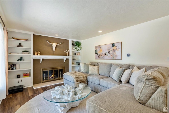 1680 E Fieldcrest Ln, Holladay, UT 84117 - living room featuring wood finished floors, a glass covered fireplace, recessed lighting, and built in shelves
