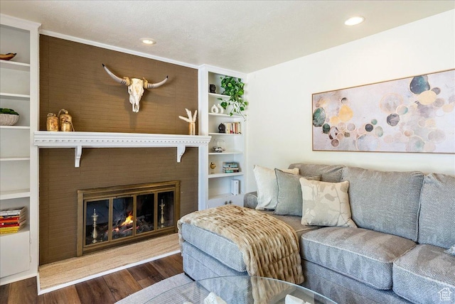1680 E Fieldcrest Ln, Holladay, UT 84117 - living room with wood finished floors, a glass covered fireplace, built in features, and recessed lighting