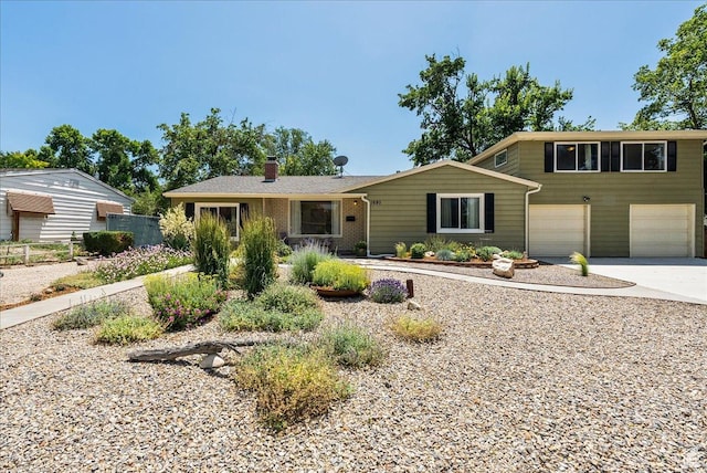1680 E Fieldcrest Ln, Holladay, UT 84117 - view of front of house featuring concrete driveway, a chimney, and an attached garage