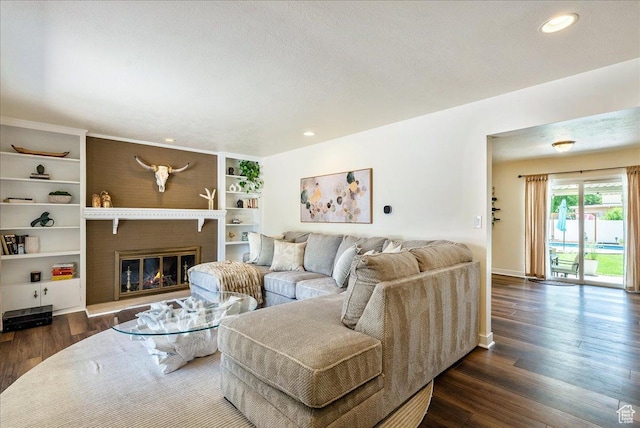 1680 E Fieldcrest Ln, Holladay, UT 84117 - living room featuring dark wood-type flooring, a glass covered fireplace, and recessed lighting