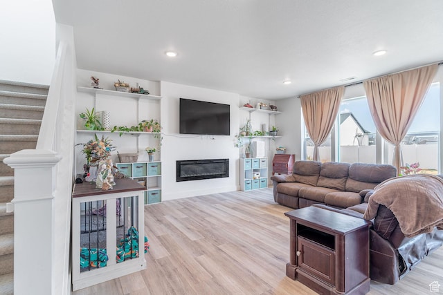 2477 W 2900 N, Farr West, UT 84404 - living area with a glass covered fireplace, wood finished floors, recessed lighting, and stairs
