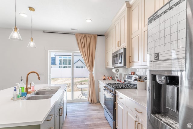 2477 W 2900 N, Farr West, UT 84404 - kitchen with appliances with stainless steel finishes, light countertops, backsplash, light wood finished floors, and recessed lighting