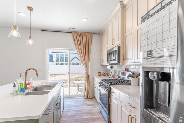 2477 W 2900 N, Farr West, UT 84404 - kitchen with appliances with stainless steel finishes, light countertops, backsplash, light wood finished floors, and recessed lighting