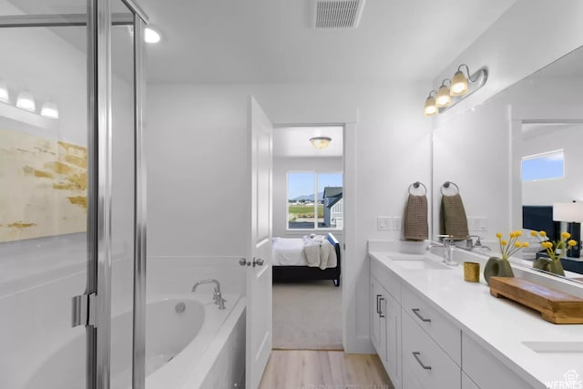 2477 W 2900 N, Farr West, UT 84404 - full bath featuring ensuite bathroom, double vanity, a garden tub, wood finished floors, and a stall shower