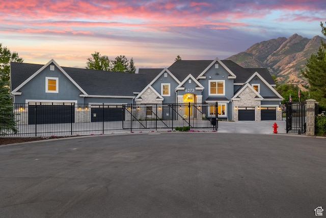 6273 S Oakcrest Cir, Holladay, UT 84121 - view of front of home with stone siding, driveway, a garage, a mountain view, and stucco siding