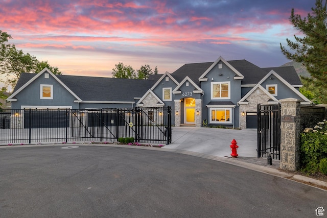 6273 S Oakcrest Cir, Holladay, UT 84121 - view of front of house with stone siding, driveway, a gate, stucco siding, and a garage