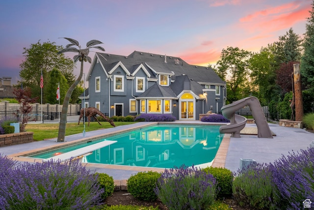6273 S Oakcrest Cir, Holladay, UT 84121 - back of property at dusk with a patio and french doors
