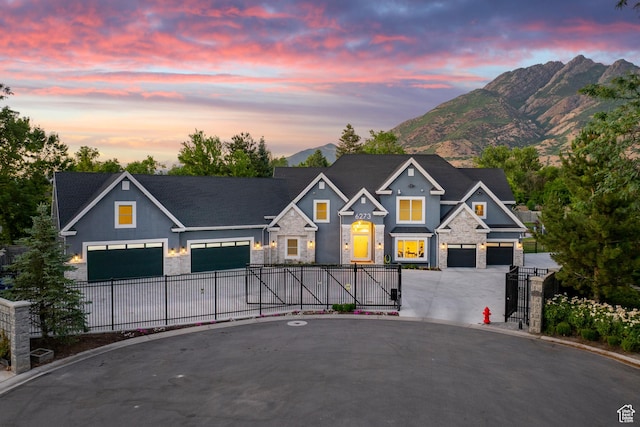 6273 S Oakcrest Cir, Holladay, UT 84121 - view of front of property with stone siding, a gate, curved driveway, and a mountain view
