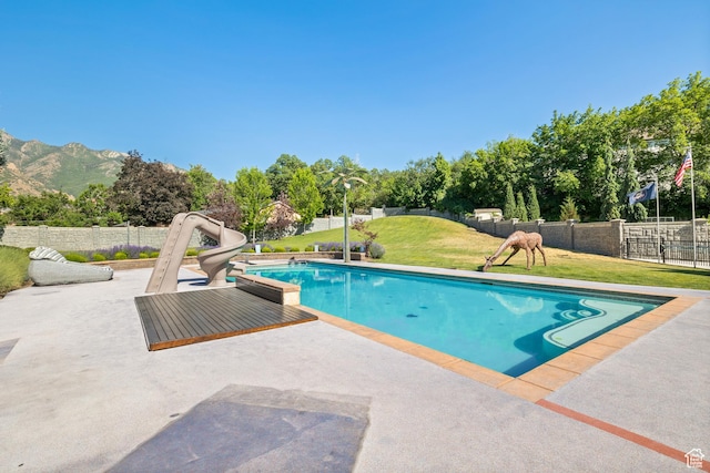 6273 S Oakcrest Cir, Holladay, UT 84121 - view of swimming pool featuring a water slide, a patio, and a mountain view
