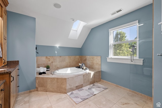 6273 S Oakcrest Cir, Holladay, UT 84121 - bathroom featuring a skylight, vanity, a garden tub, vaulted ceiling, and tile patterned flooring
