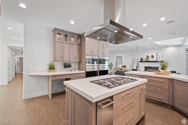 6273 S Oakcrest Cir, Holladay, UT 84121 - kitchen featuring island range hood, stainless steel appliances, a warm lit fireplace, light countertops, and recessed lighting