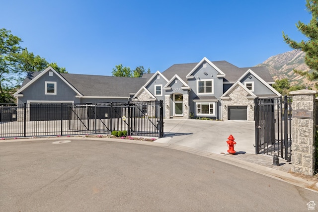 6273 S Oakcrest Cir, Holladay, UT 84121 - view of front of house with stone siding, concrete driveway, a gate, an attached garage, and a mountain view
