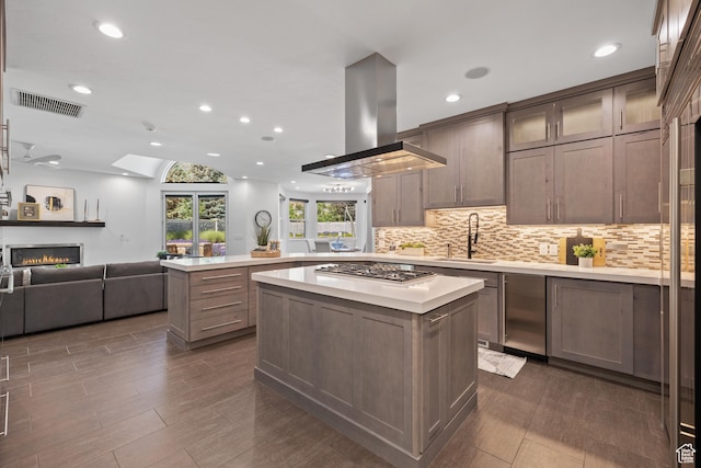 6273 S Oakcrest Cir, Holladay, UT 84121 - kitchen featuring island exhaust hood, light countertops, a peninsula, recessed lighting, and open floor plan