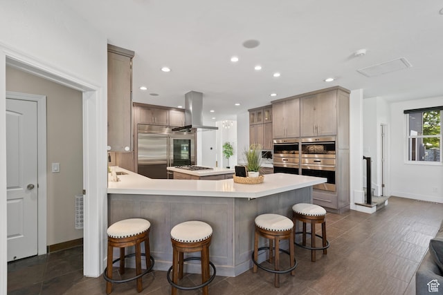 6273 S Oakcrest Cir, Holladay, UT 84121 - kitchen with island exhaust hood, stainless steel appliances, a breakfast bar area, light countertops, and recessed lighting