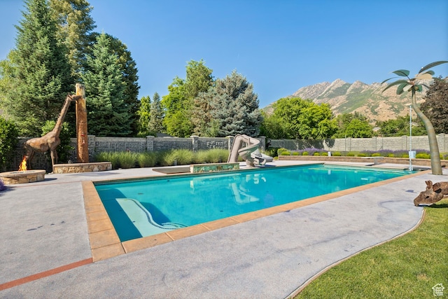 6273 S Oakcrest Cir, Holladay, UT 84121 - view of swimming pool featuring a mountain view, a water slide, and a patio area