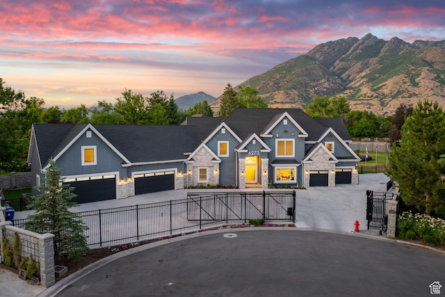 6273 S Oakcrest Cir, Holladay, UT 84121 - craftsman-style home with stone siding, a gate, driveway, and a mountain view