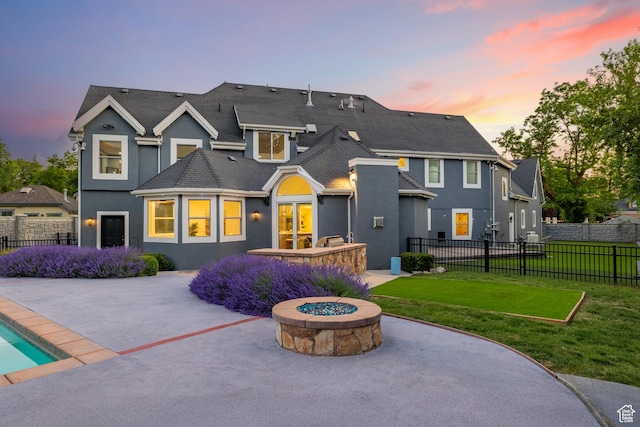 6273 S Oakcrest Cir, Holladay, UT 84121 - back of house at dusk with a patio area, stucco siding, and a fire pit