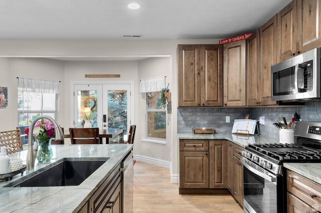 1524 E 330 N, Lehi, UT 84043 - kitchen with appliances with stainless steel finishes, light stone countertops, backsplash, light wood-style flooring, and recessed lighting