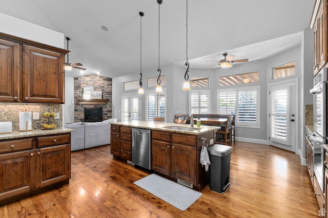 1524 E 330 N, Lehi, UT 84043 - kitchen with a ceiling fan, stainless steel appliances, a stone fireplace, open floor plan, and wood finished floors