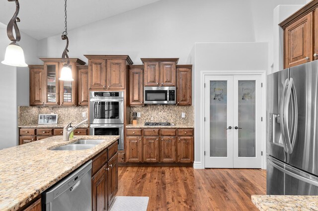 1524 E 330 N, Lehi, UT 84043 - kitchen with appliances with stainless steel finishes, hanging light fixtures, tasteful backsplash, brown cabinets, and high vaulted ceiling