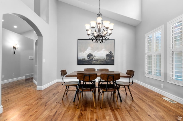 1524 E 330 N, Lehi, UT 84043 - dining room with arched walkways, high vaulted ceiling, light wood-type flooring, a chandelier, and healthy amount of natural light