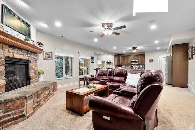 1524 E 330 N, Lehi, UT 84043 - living room with light colored carpet, a ceiling fan, a stone fireplace, recessed lighting, and arched walkways