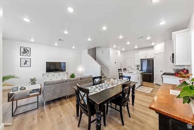 6029 S Carnelian Pkwy, St George, UT 84790 - dining room featuring stairway, light wood-style floors, and recessed lighting