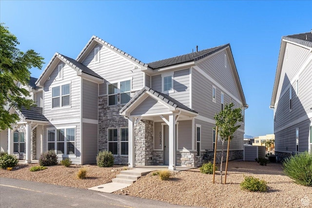 6029 S Carnelian Pkwy, St George, UT 84790 - traditional home with stone siding, a porch, and a tiled roof