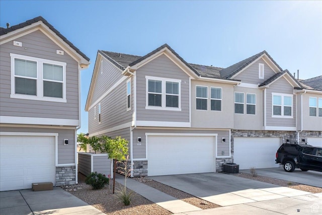 6029 S Carnelian Pkwy, St George, UT 84790 - view of front of house featuring stone siding, an attached garage, and driveway