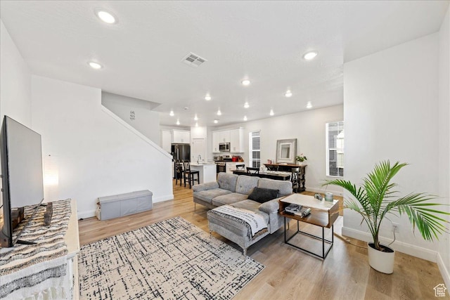 6029 S Carnelian Pkwy, St George, UT 84790 - living room featuring light wood finished floors, stairway, and recessed lighting