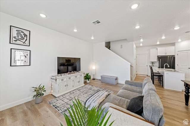 6029 S Carnelian Pkwy, St George, UT 84790 - living room with light wood-type flooring, stairway, and recessed lighting