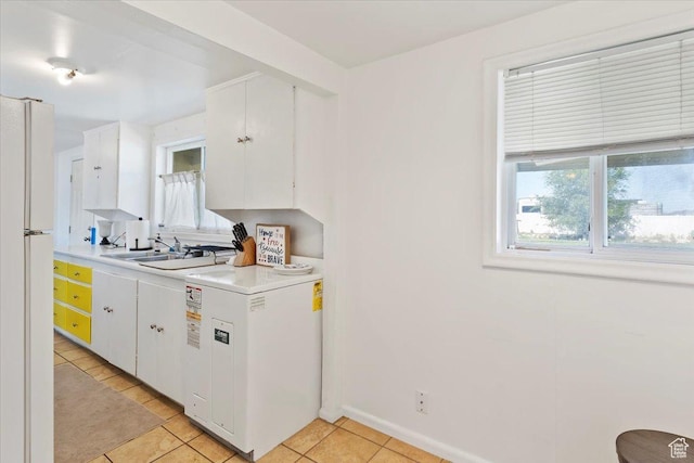 1975 N 2000 W, Farr West, UT 84404 - kitchen featuring freestanding refrigerator, light countertops, white cabinets, and light tile patterned floors