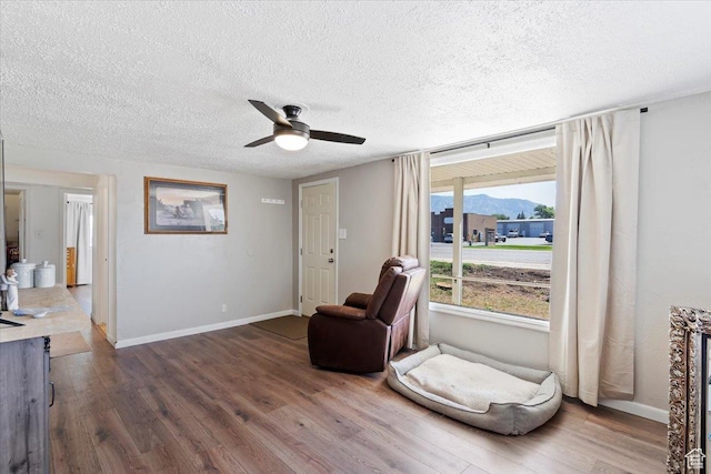 1975 N 2000 W, Farr West, UT 84404 - sitting room featuring a mountain view, ceiling fan, dark wood finished floors, and a textured ceiling