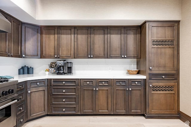 7815 Royal St Unit C259, Park City, UT 84060 - kitchen with stainless steel gas range oven, light countertops, exhaust hood, and light wood finished floors