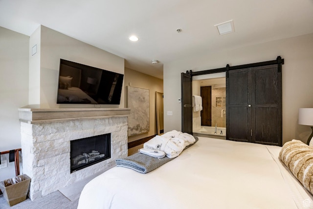 7815 Royal St Unit C259, Park City, UT 84060 - carpeted bedroom featuring a fireplace, a barn door, ensuite bathroom, and recessed lighting