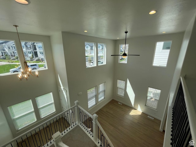 4332 W Watchmen Way, Herriman, UT 84096 - stairs featuring recessed lighting, wood finished floors, ceiling fan, a high ceiling, and a chandelier