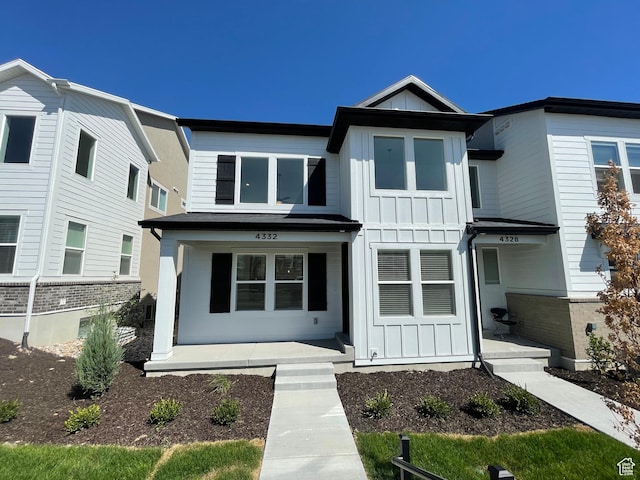 4332 W Watchmen Way, Herriman, UT 84096 - view of front of home featuring board and batten siding and a porch