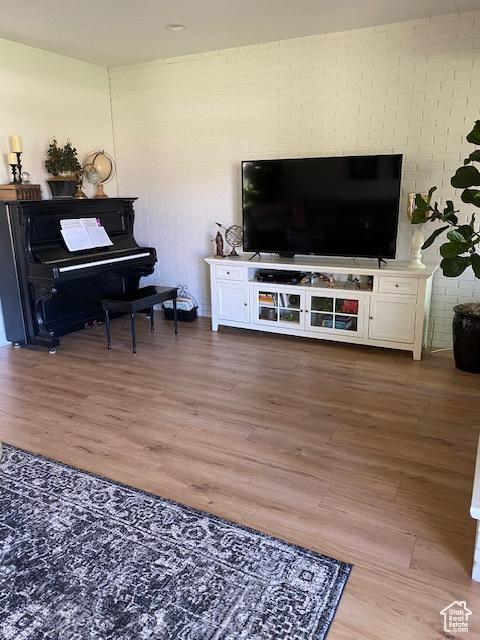 1014 W Bloomington Dr S, St George, UT 84790 - living room featuring wood finished floors and brick wall