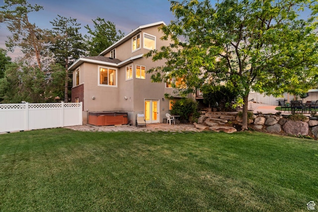 14012 S Osborne Ln E, Draper, UT 84020 - rear view of house with a hot tub, stucco siding, a patio, and a fenced backyard