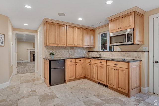 14012 S Osborne Ln E, Draper, UT 84020 - kitchen featuring stainless steel microwave, freestanding refrigerator, dark stone countertops, recessed lighting, and tasteful backsplash